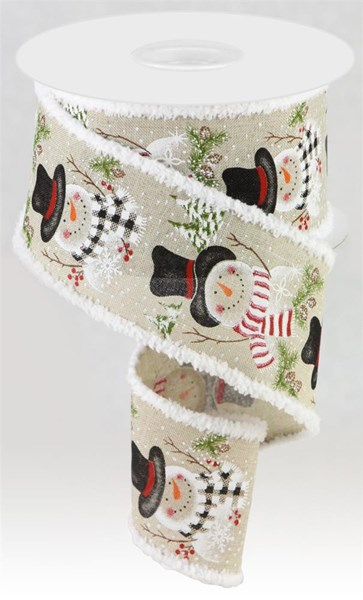 2.5 inch snowman and pine branch print ribbon on light natural fabric with white fuzzy edges.