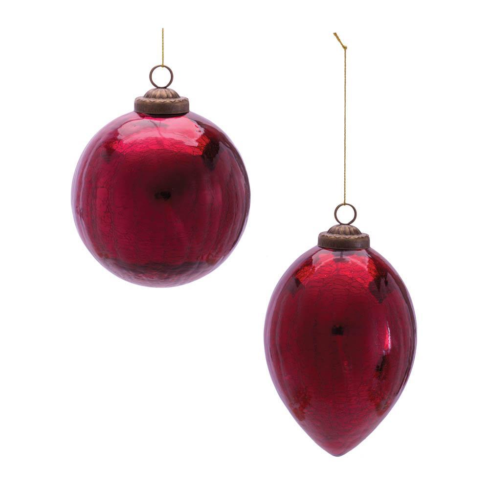 Red glass Christmas ornaments, one round and one teardrop shaped, with a textured finish.