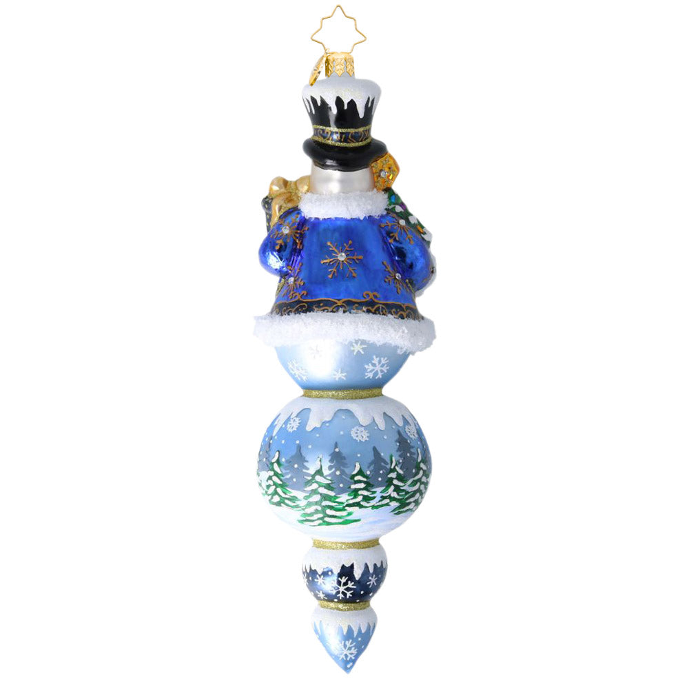 The Regal Snowman Drop glass ornament featuring a snowman in a blue coat above a winter landscape.