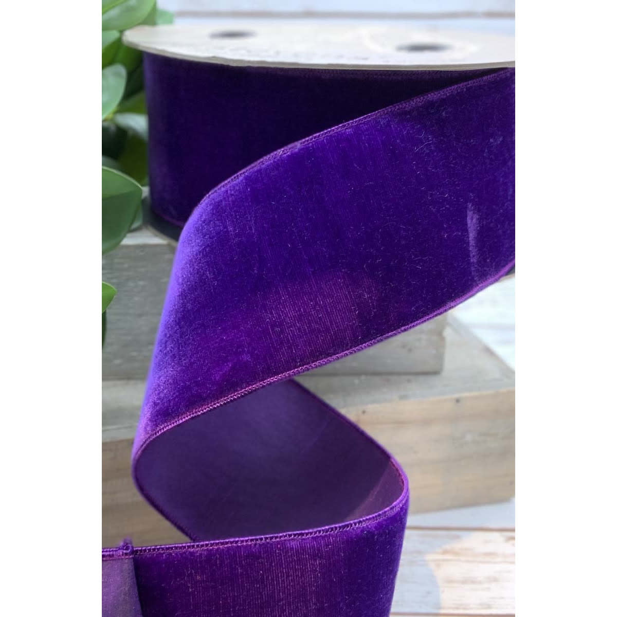 A roll of bright purple velvet ribbon with a faux dupion back, 2.5 inches wide.