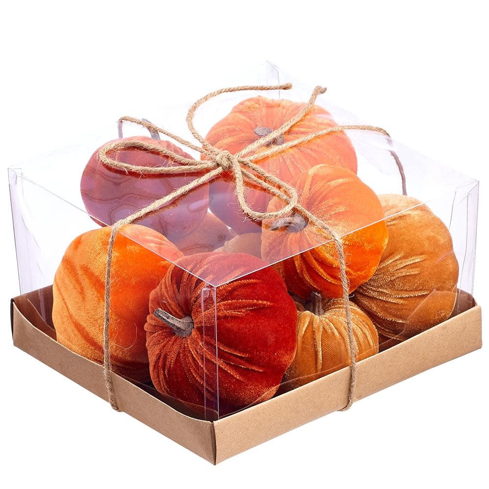 Set of orange brown velvet pumpkins with jute rope handles on a white background.