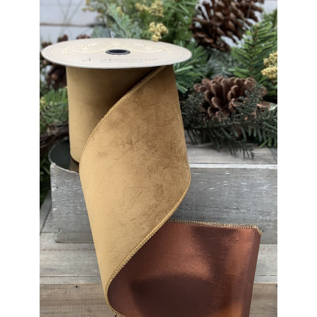 A roll of 2.5-inch wide ribbon with a gold velvet front and a metallic copper taffeta back.