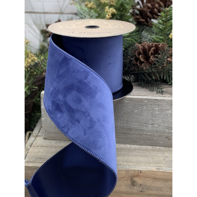 A roll of cobalt blue velvet ribbon measuring 2.5 inches wide by 10 yards long.