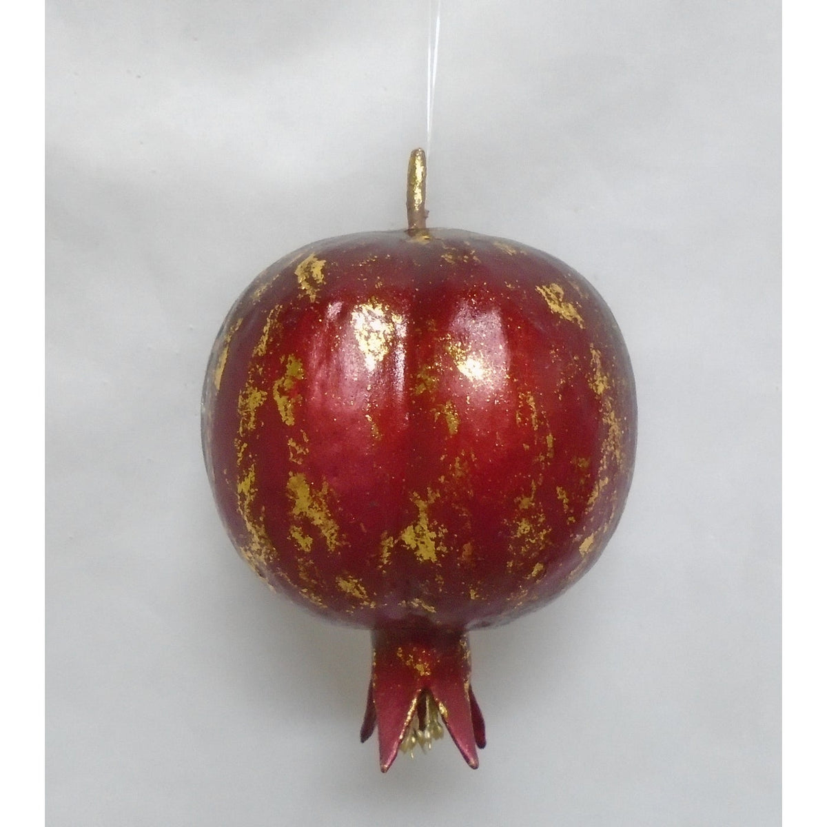 Medium burgundy pomegranate ornament with gold metallic antiquing and a hanging loop.