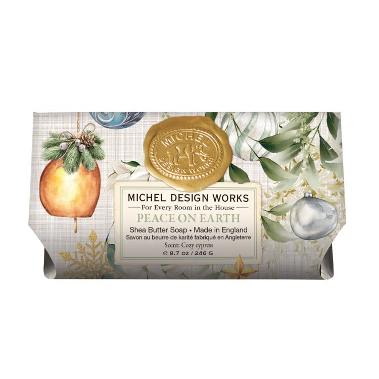 Michel Design Works Peace on Earth shea butter soap bar with holiday ornament and greenery design.