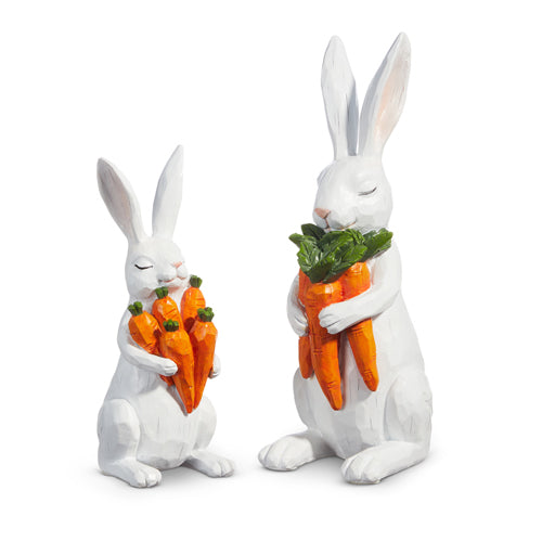 Resin bunny figurine holding a carrot in pastel pink with white accents.