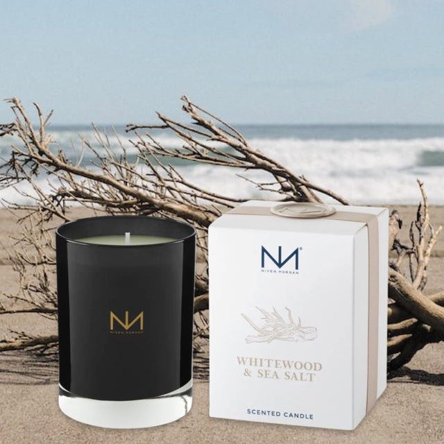 Dark navy glass soy blend candle with white label reading Whitewood & Sea Salt