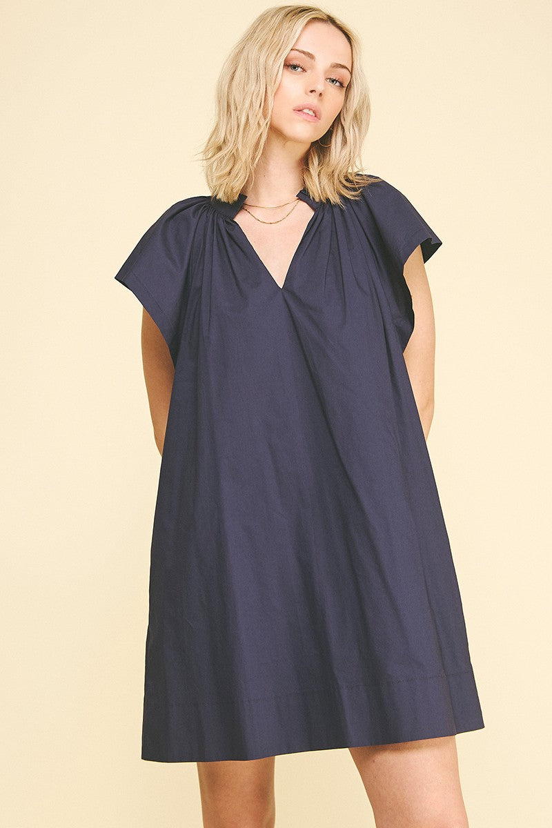 Amelia cotton mini dress with ruffle detailing in a light neutral tone