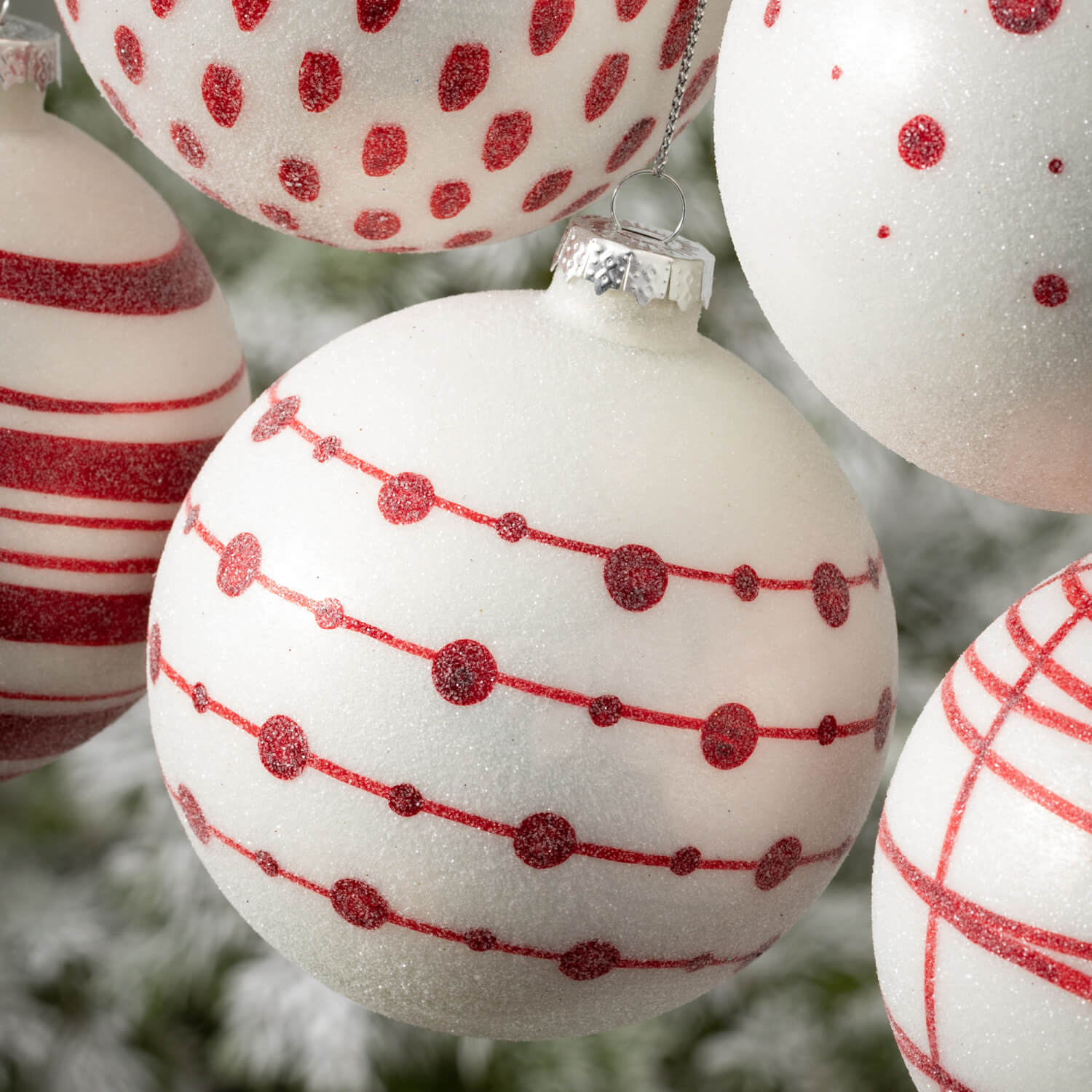 Multicolor glass ball ornament with a geometric patterned surface.
