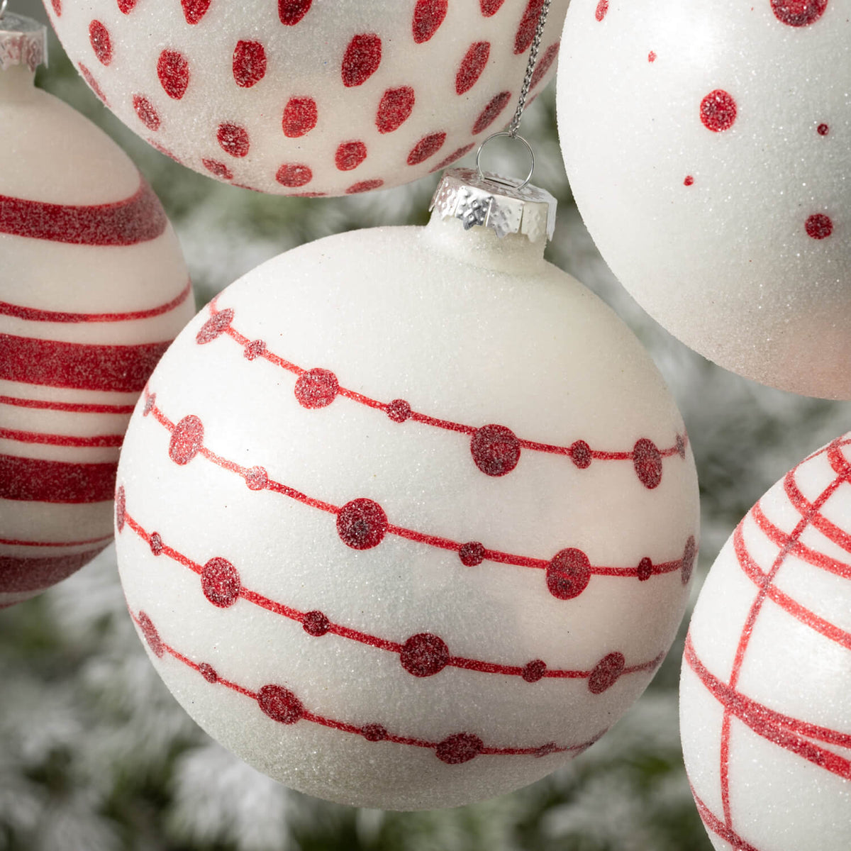Multicolor glass ball ornament with a geometric patterned surface.