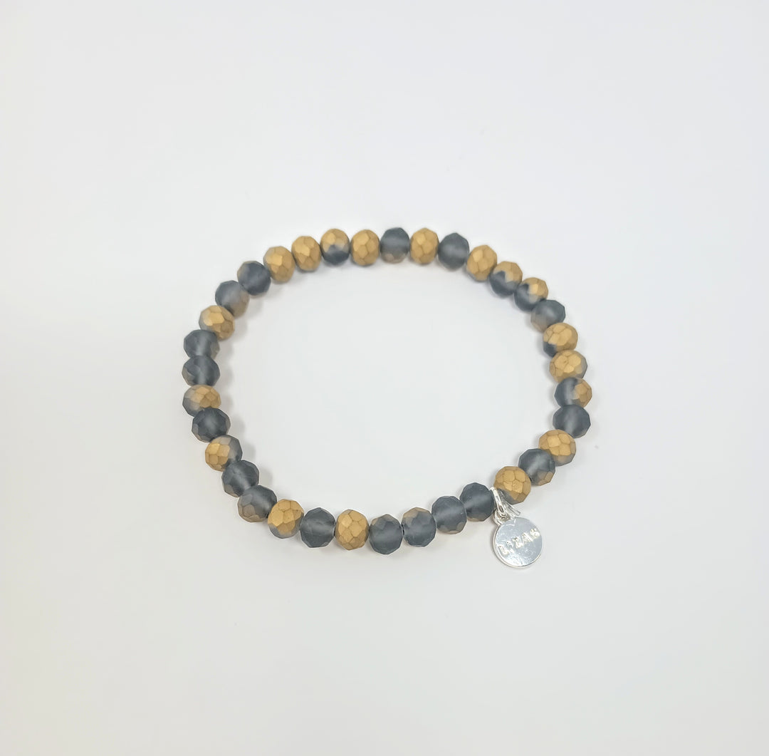 Stretchy bracelet with faceted glass beads in a colorful beaded pattern.