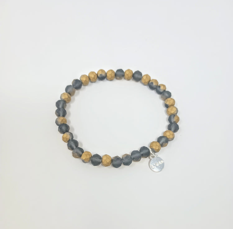 Stretchy bracelet with faceted glass beads in a colorful beaded pattern.