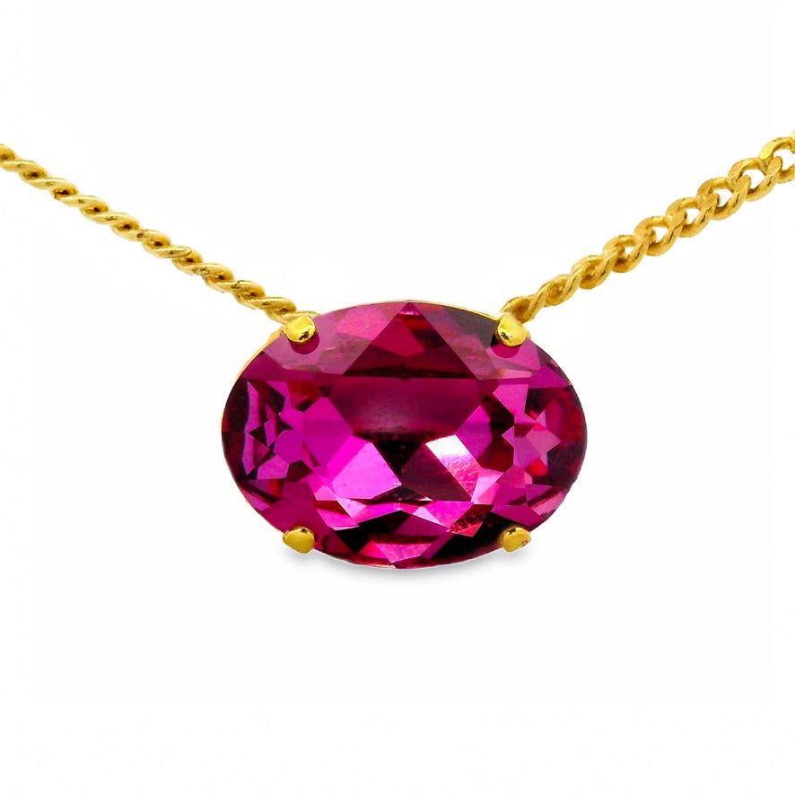 Mega Iza Necklace featuring a large oval pink gemstone set in a gold-tone chain.