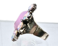 Side view of a silver metal flower ring featuring a large pink stone and opal accents.