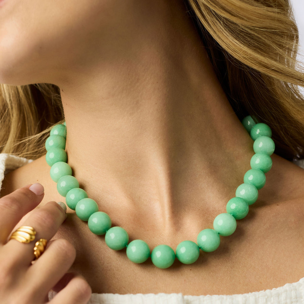 Adjustable Portofino beaded necklace with toggle clasp featuring gold plate beads and green jade accents.