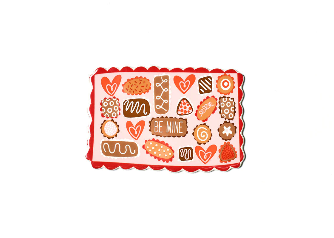 Valentine's Day chocolate box sticker with assorted heart and cookie shapes on a pink background.