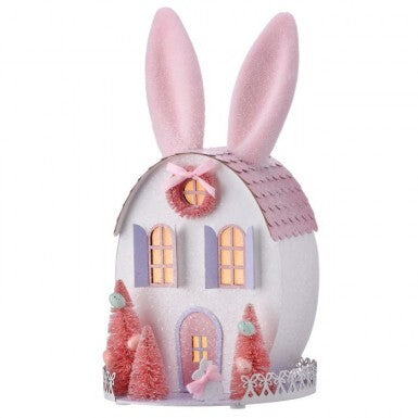 Cardboard Easter bunny house with sisal trees, glitter flocking, ribbon trim, and internal LED lights.