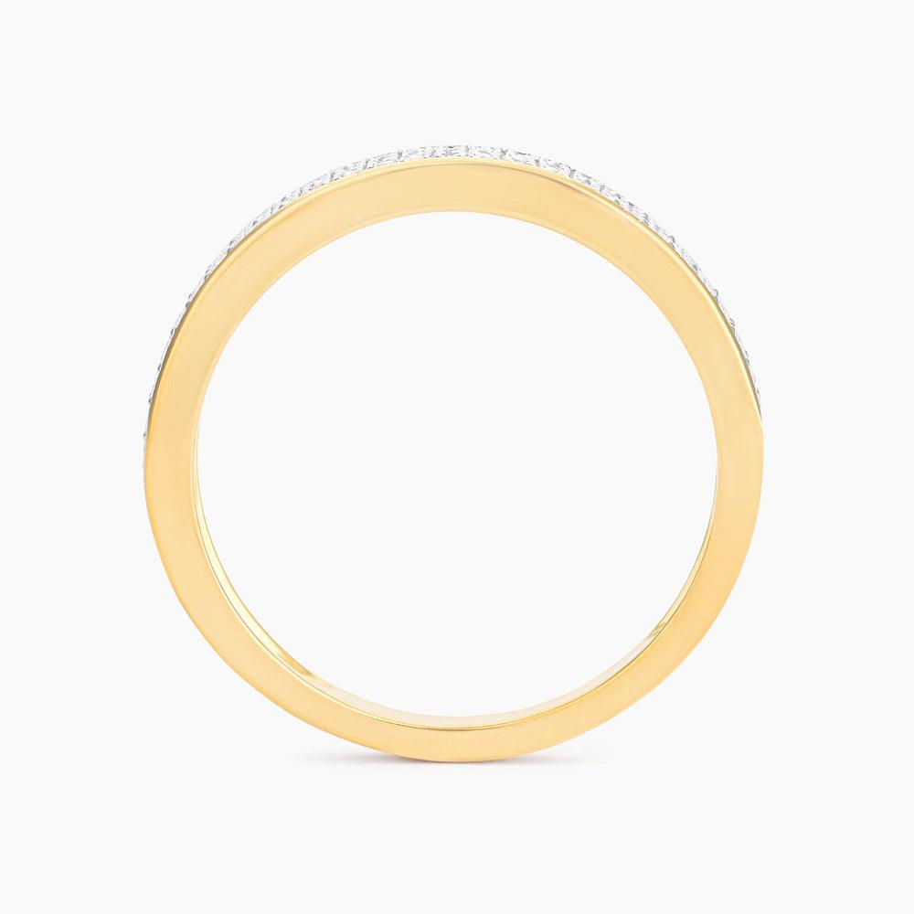 Side view of a gold stackable band ring with small diamonds set along the top edge.