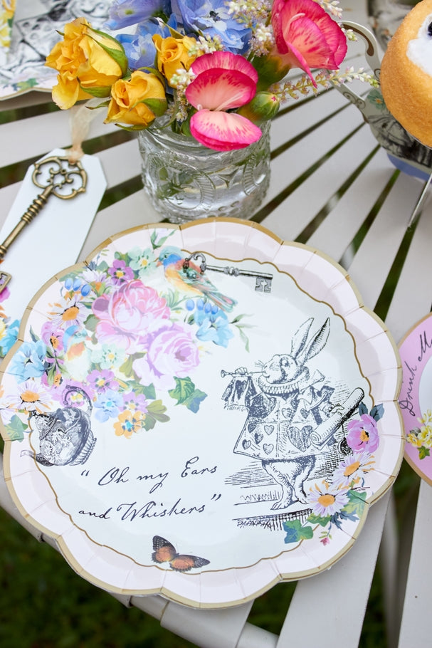 Small white ceramic plate featuring an Alice in Wonderland illustration with a whimsical silhouette.
