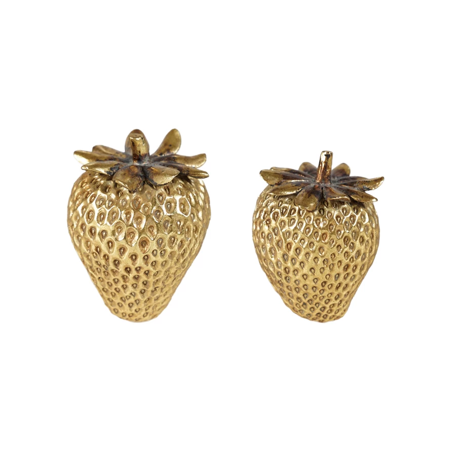 Gold-finish resin strawberry figurine with a glossy surface.