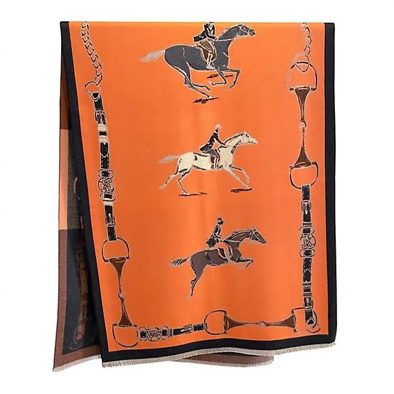 Orange reversible wrap with equestrian print featuring horses, riders, and bit-and-chain border.