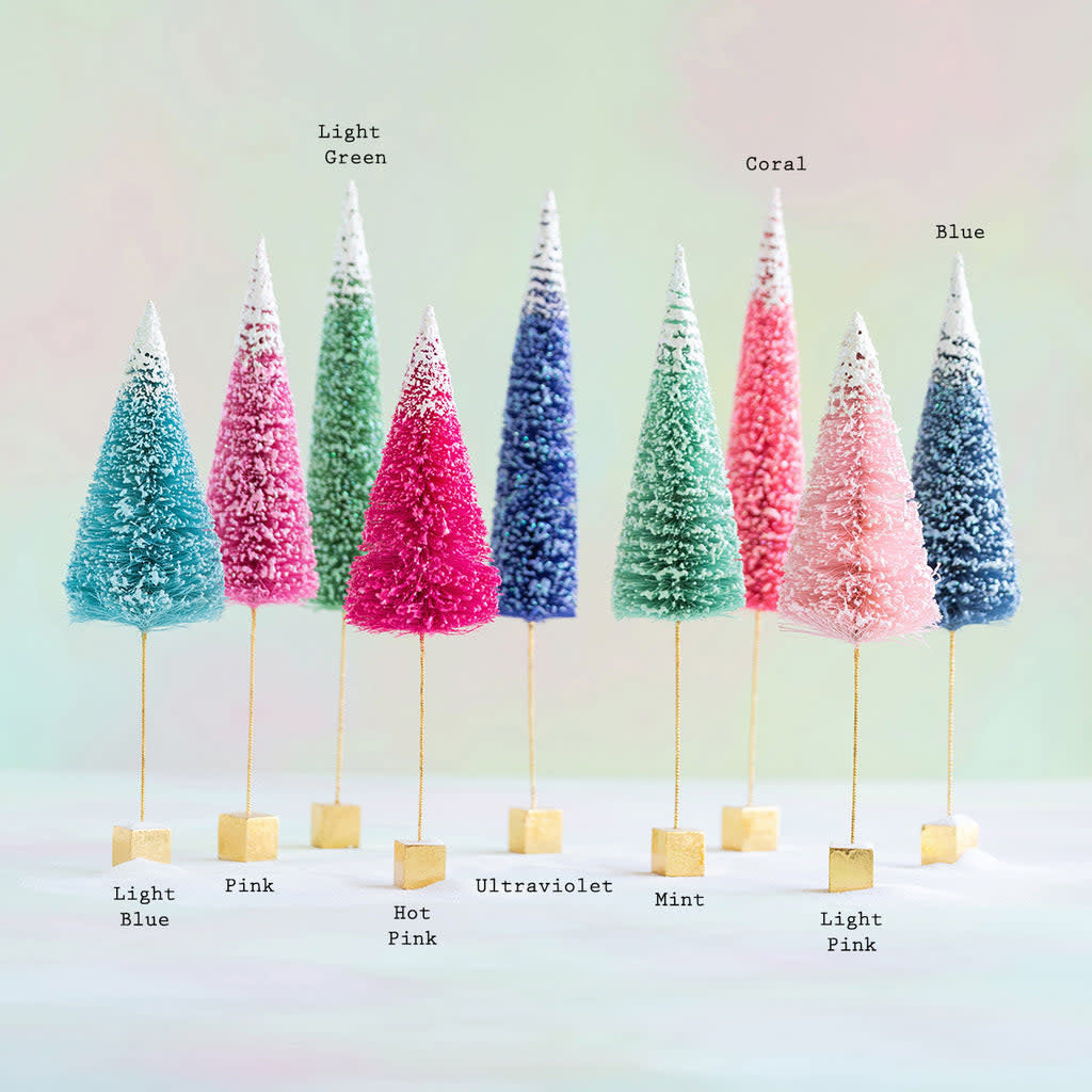 Large frosted sugar sisal tree with a natural brown trunk and white-tipped leaves in an artificial holiday silhouette.