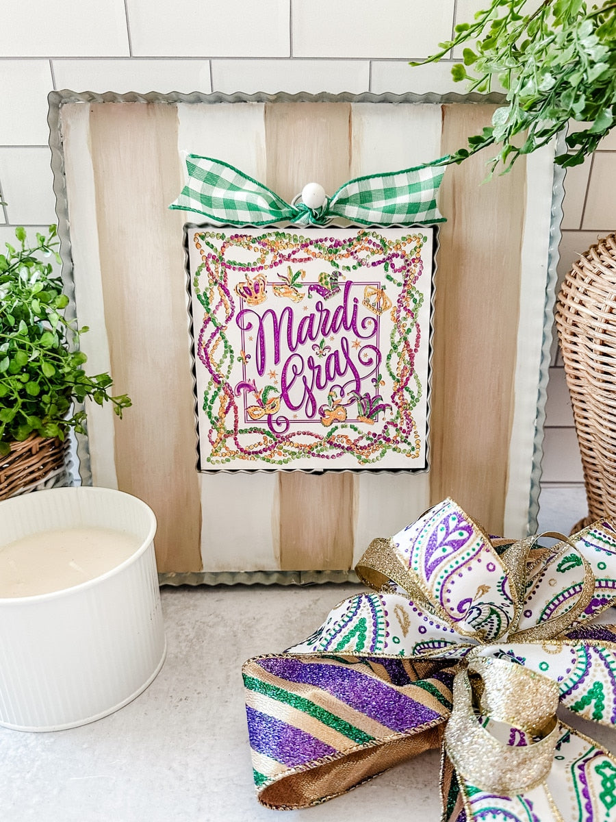 Mini Beck's Mardi Gras hanging decoration featuring a festive mask with purple, green, and gold colors.