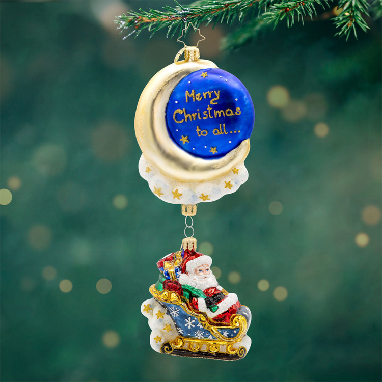 Moonlight Sleigh Ride ornament with Santa in a sleigh hanging below a crescent moon and night sky.