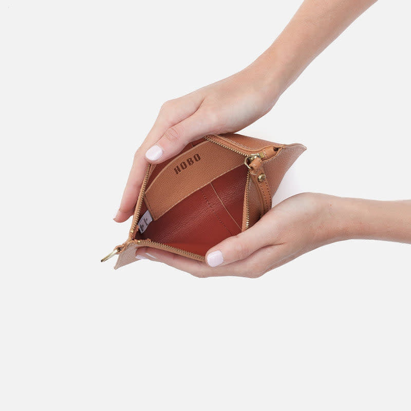 Open biscuit-colored leather Vida small pouch with coconut shell interior lining.