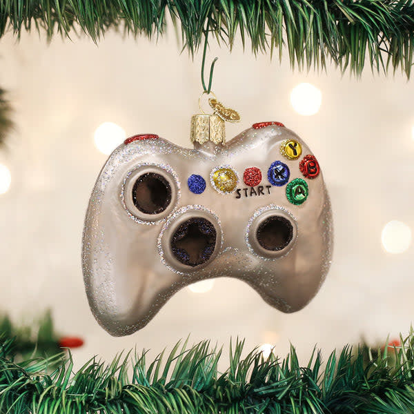Glass ornament shaped like a video game controller with hand-painted silver accents.