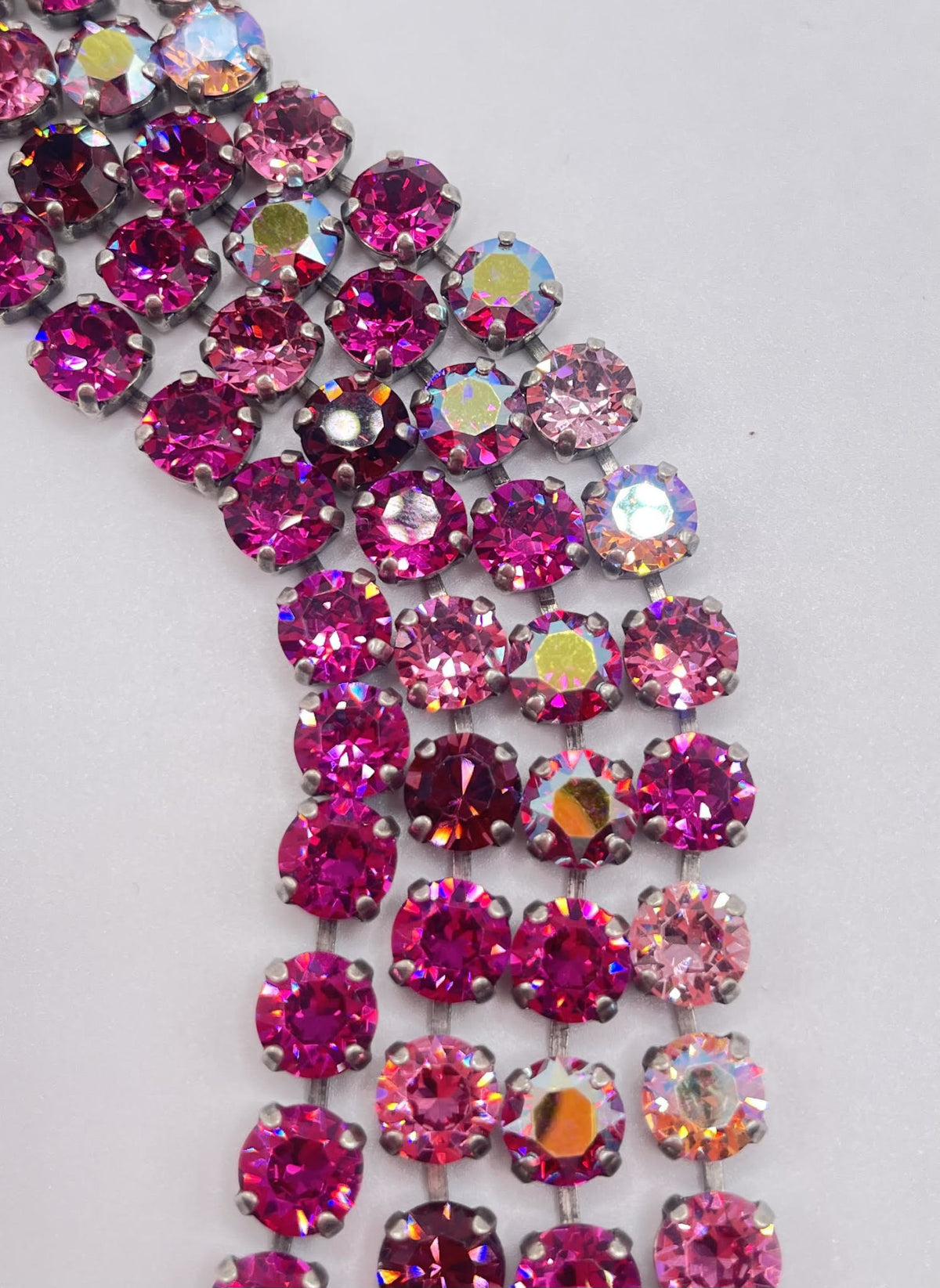 Vienna bracelet featuring four rows of round, faceted pink and iridescent crystals in silver settings.