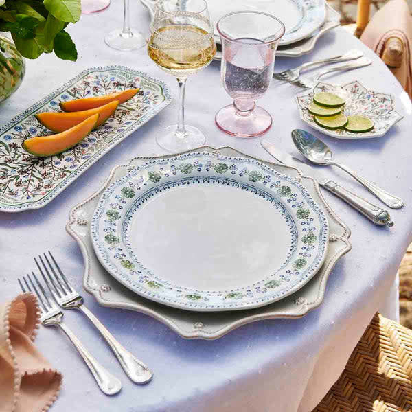 Chambray ceramic dinner plate with scalloped rim featuring intricate floral motif inspired by Spanish tiles