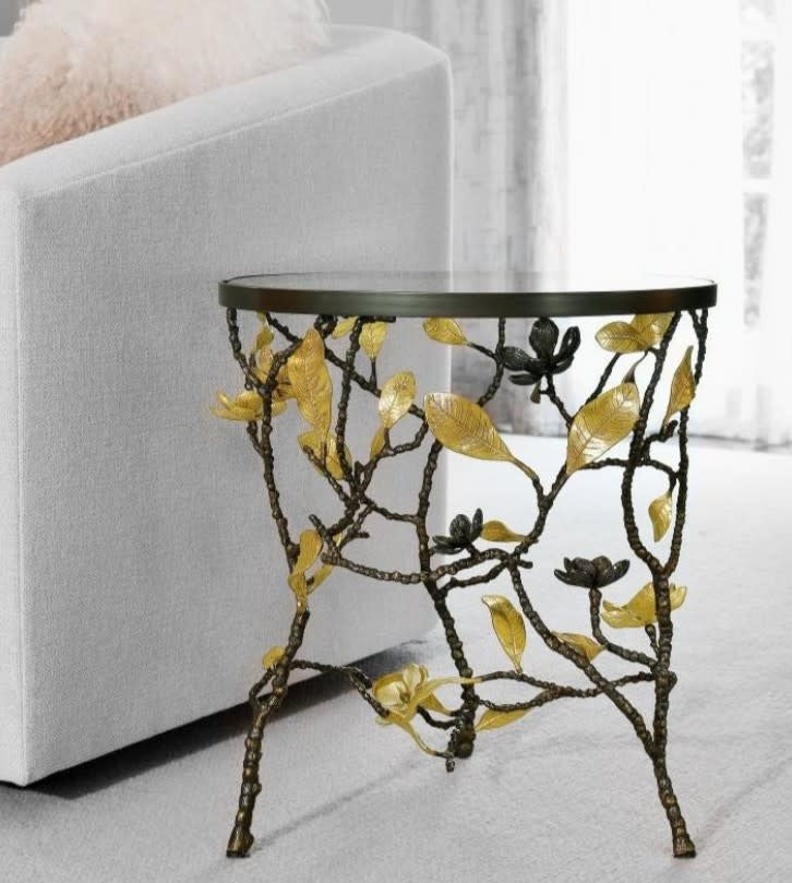 Vintage Bloom side table with a distressed wood finish, curved legs, and an open shelf.