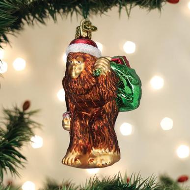 Santa Sasquatch ornament featuring a red-clad Santa riding on the back of a brown Bigfoot figure.