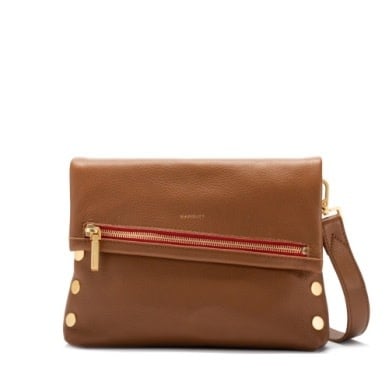 Medium zippered leather crossbody clutch in buttery black with gold rivets.