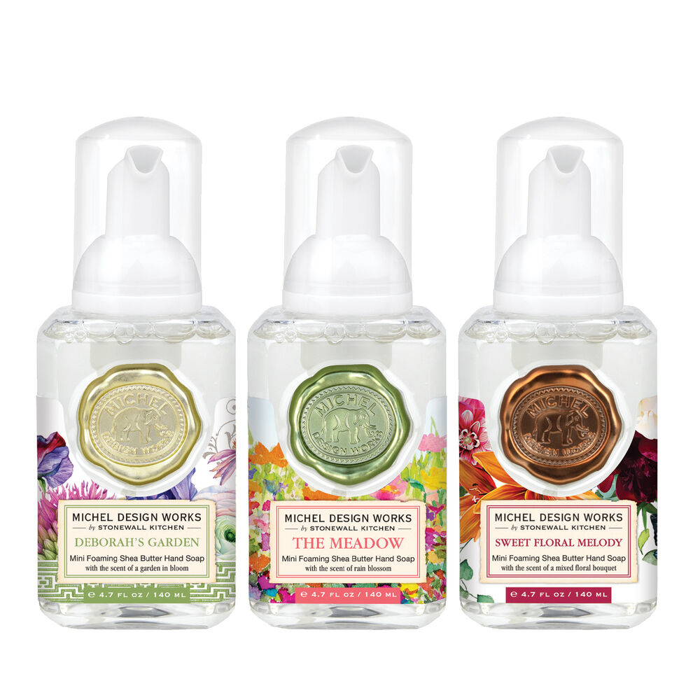 Set of three mini foaming soap dispensers in complementary scents with a compact rectangular silhouette.