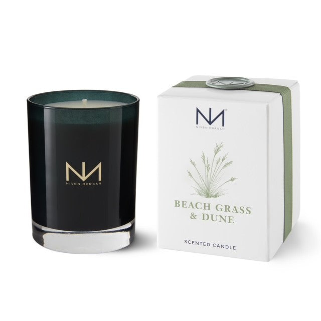 Niven Morgan Beach Grass & Dune scented candle in a dark navy glass jar next to its white box.