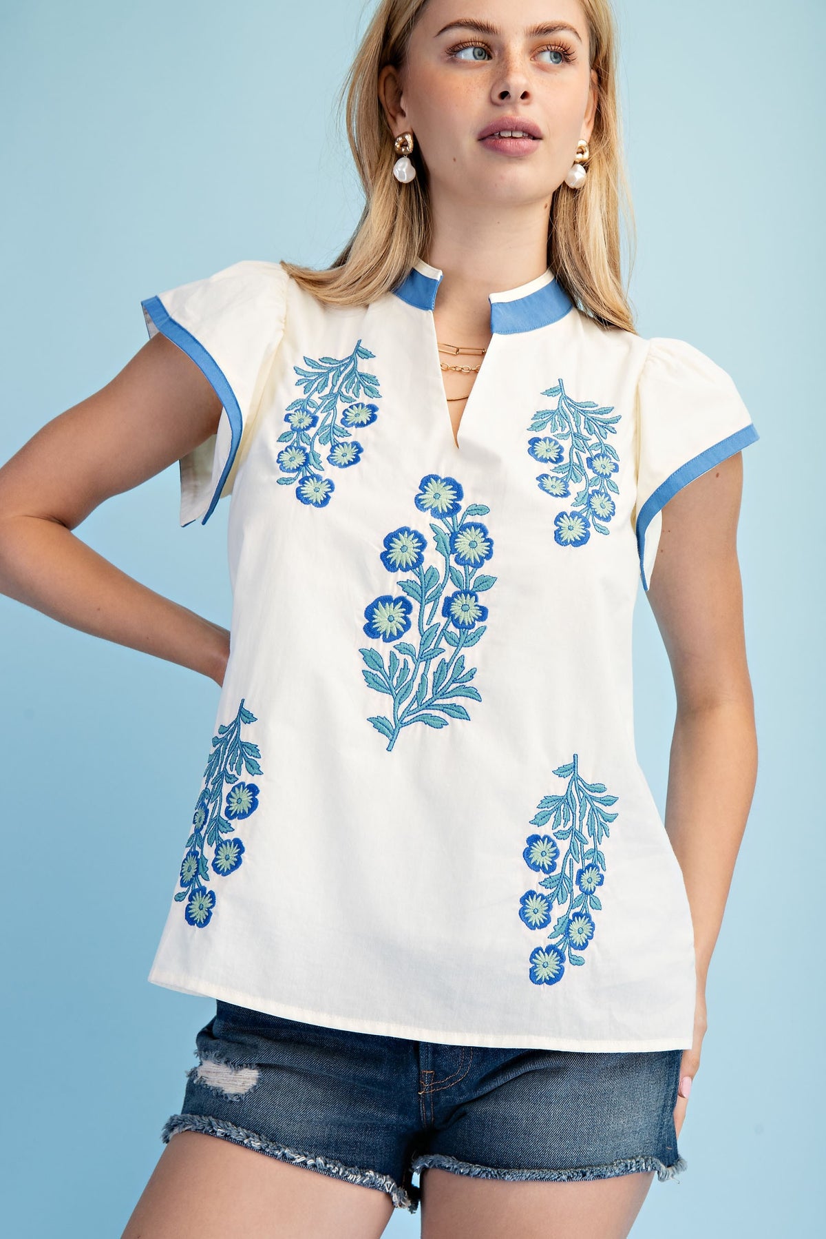 Floral embroidered cotton V-neck top with contrasting stripe trim on flutter sleeves.