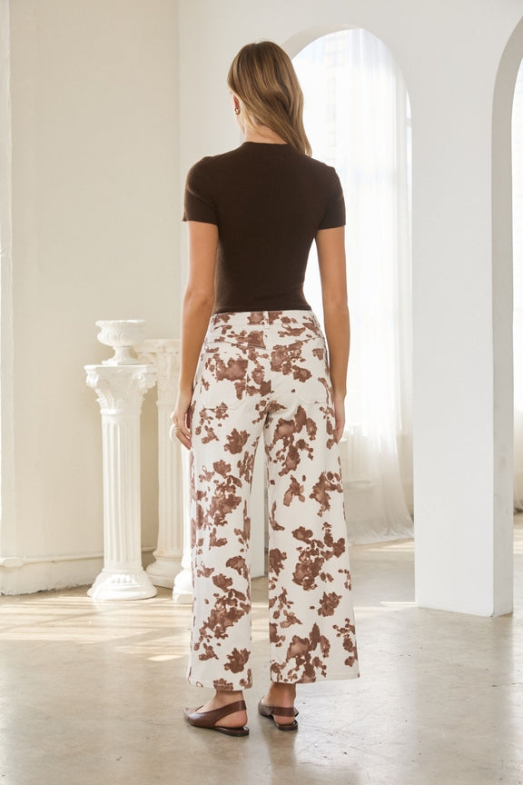 Back view of a woman wearing a brown Lucy short sleeve soft knit mock neck sweater top.