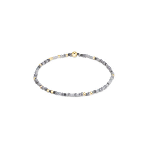 Hope Unwritten bracelet featuring mixed seed beads in various colors with gold-filled accents on stretch elastic.