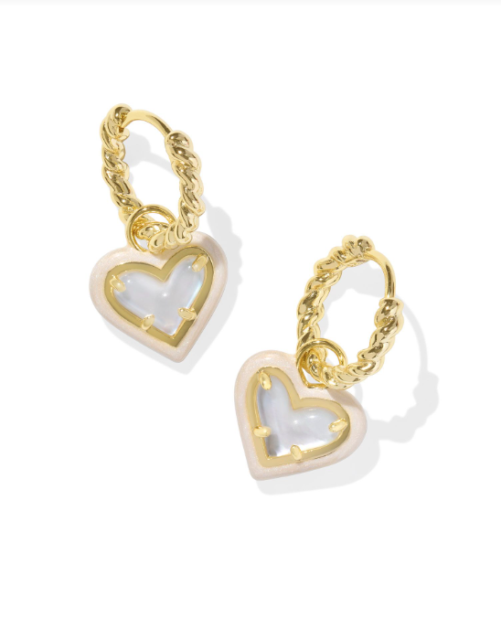 Rhodium plated silver huggie earrings with textured hoops featuring a red enamel heart charm.