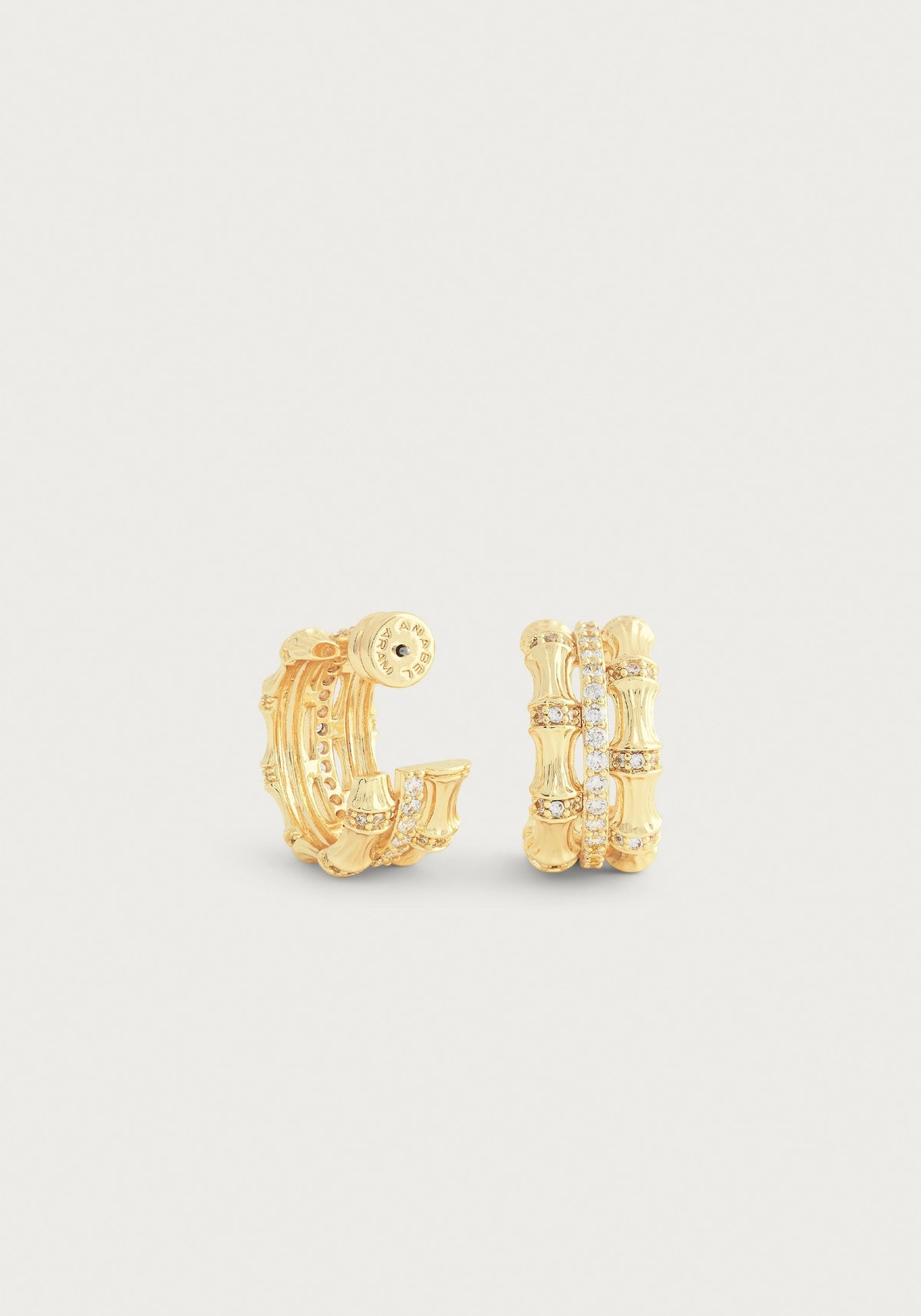 Gold-plated bamboo stacked hoop earrings with crystal pavé accents on a white background.