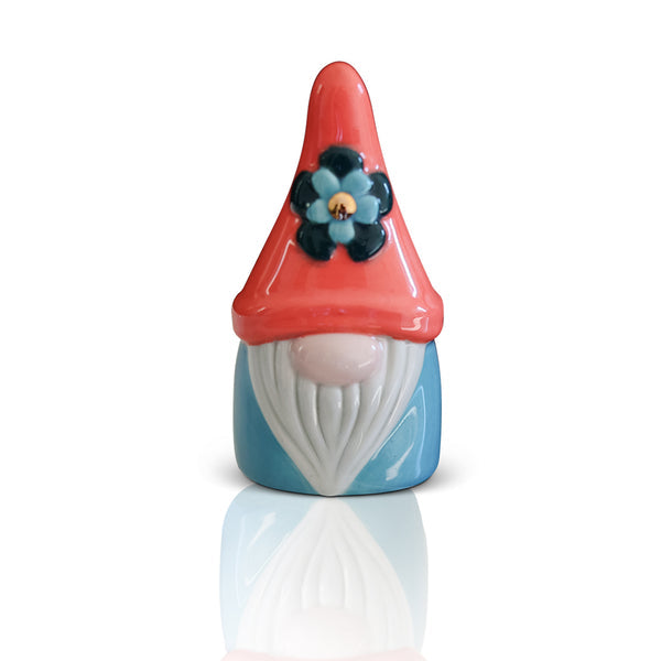 Ceramic gnome figurine with a red pointed hat, blue flower detail, white beard, and blue body.