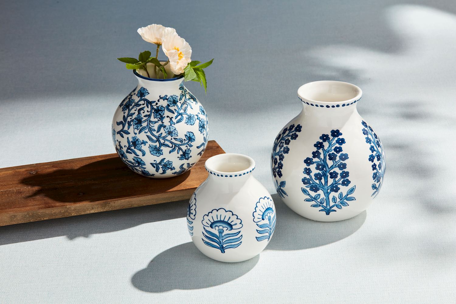 Block print flower vase with hand-painted interior floral pattern in stoneware.