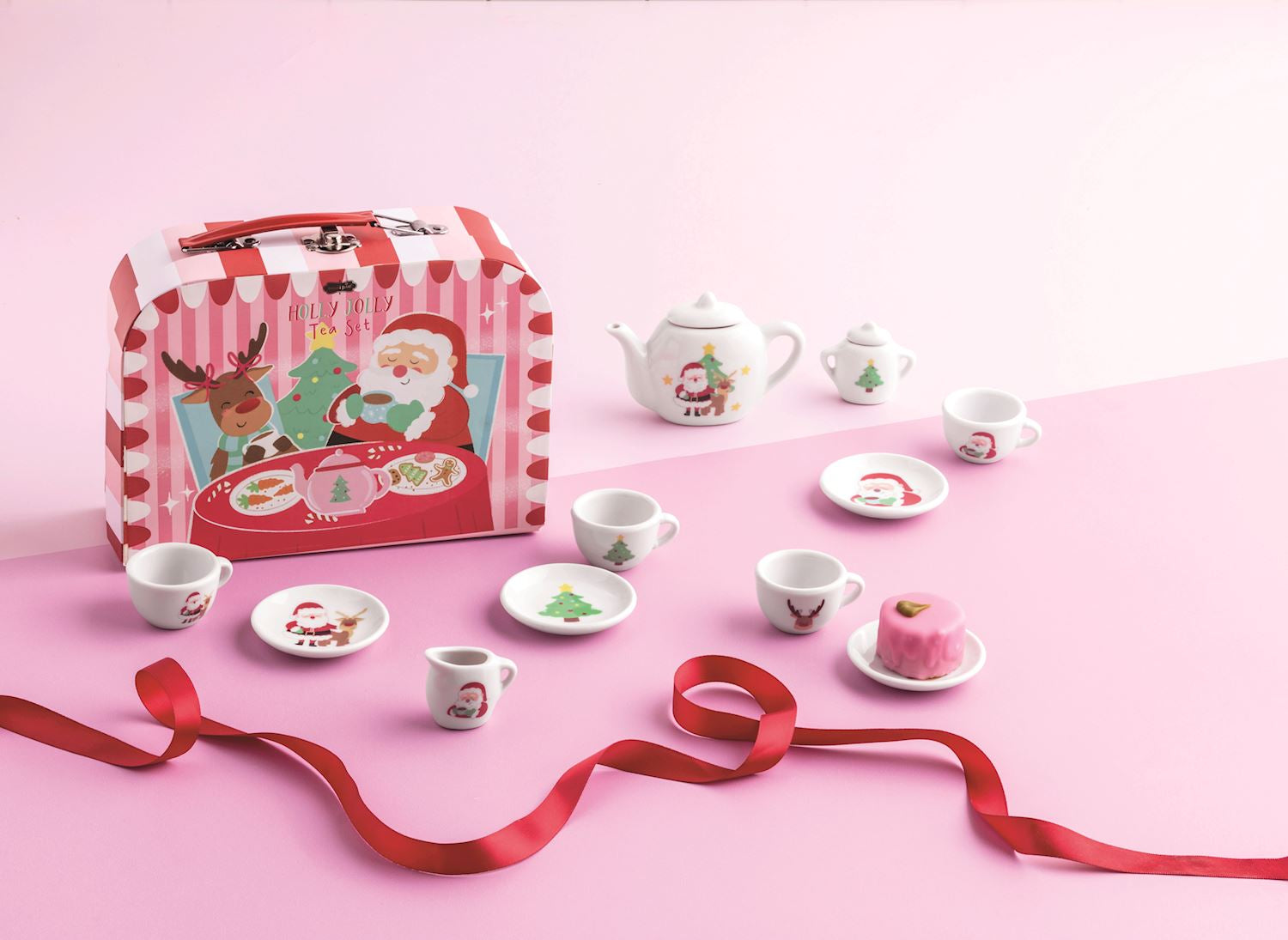Holly Jolly Tea Set with a Christmas-themed carrying case, teapot, cups, saucers, and accessories.
