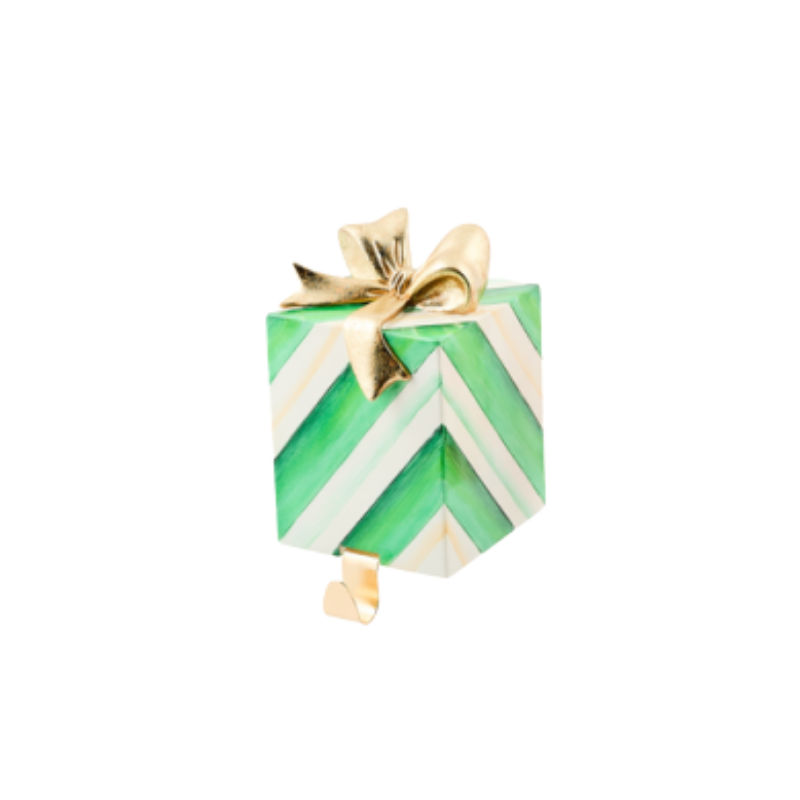 Green and white chevron gift-shaped stocking holder with a gold bow and hook.