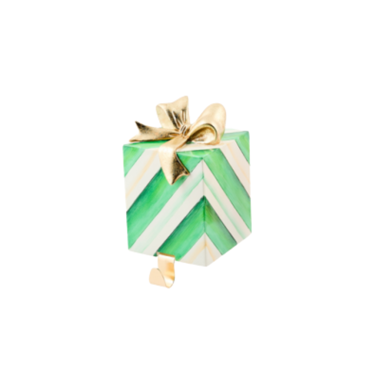 Green and white chevron gift-shaped stocking holder with a gold bow and hook.