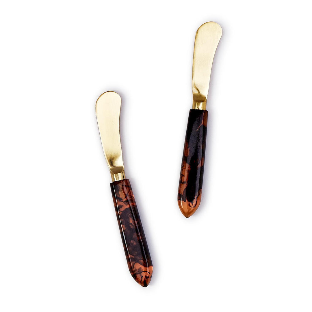 Set of two stainless steel spreaders with gold-tone blades and tortoise swirl resin handles.
