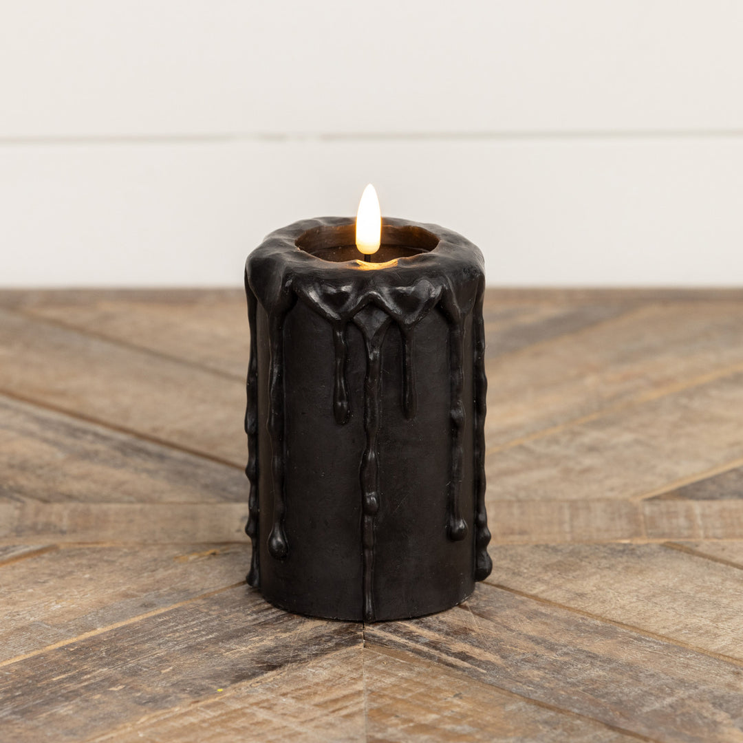 Black plastic pillar candle with a realistic flickering flame effect.