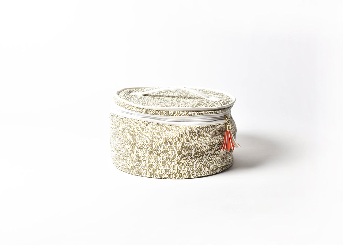 Round gold and white patterned cotton storage bag with a handle and orange tassel zipper pull.